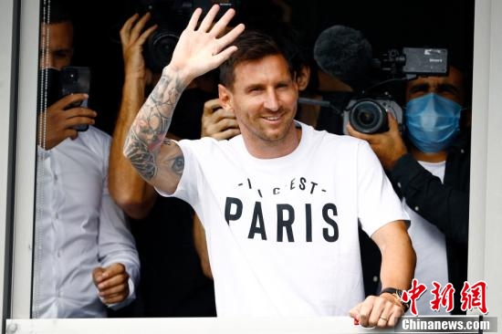 图为梅西在巴黎机场向等候的巴黎球迷招手。
